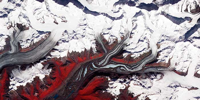 melting glaciers flow, tributaries joining to form rivers, evoking thoughts of infection spreading
