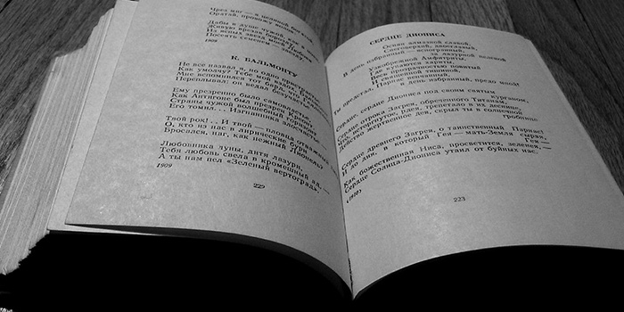 A thick book open in the middle with various visible translations