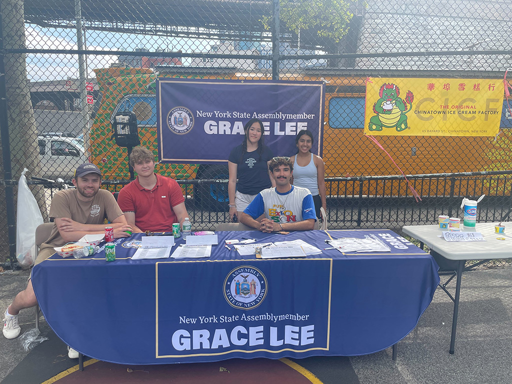 Lucca Guzman-Gieseken ’24 with other interns at a table for Grace Lee, Assembly Member for New York City’s 65th District