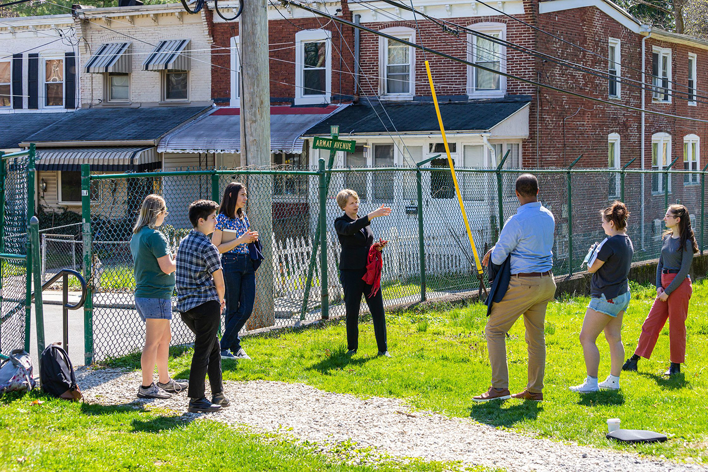 students and the president visit a local community for hands-on learning