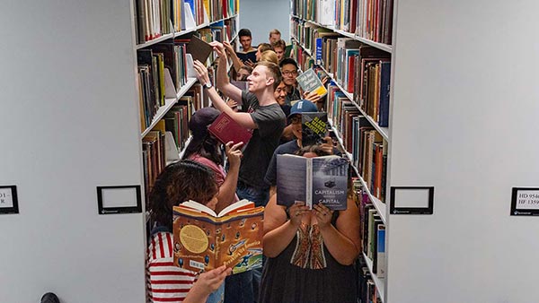 students having fun in the library stacks