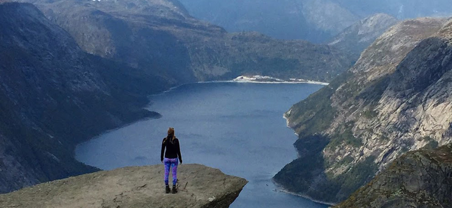 Jessie Lamworth stands on an outcropping overlooking the Hardanger Fjord