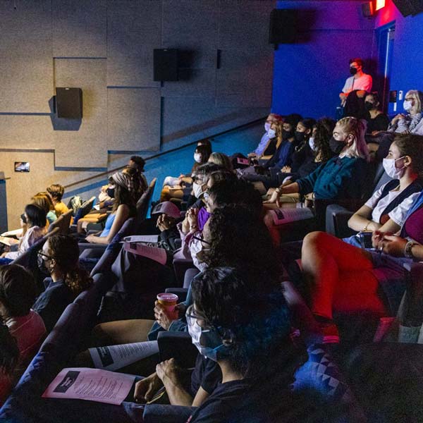 the audience watching a film premier on campus