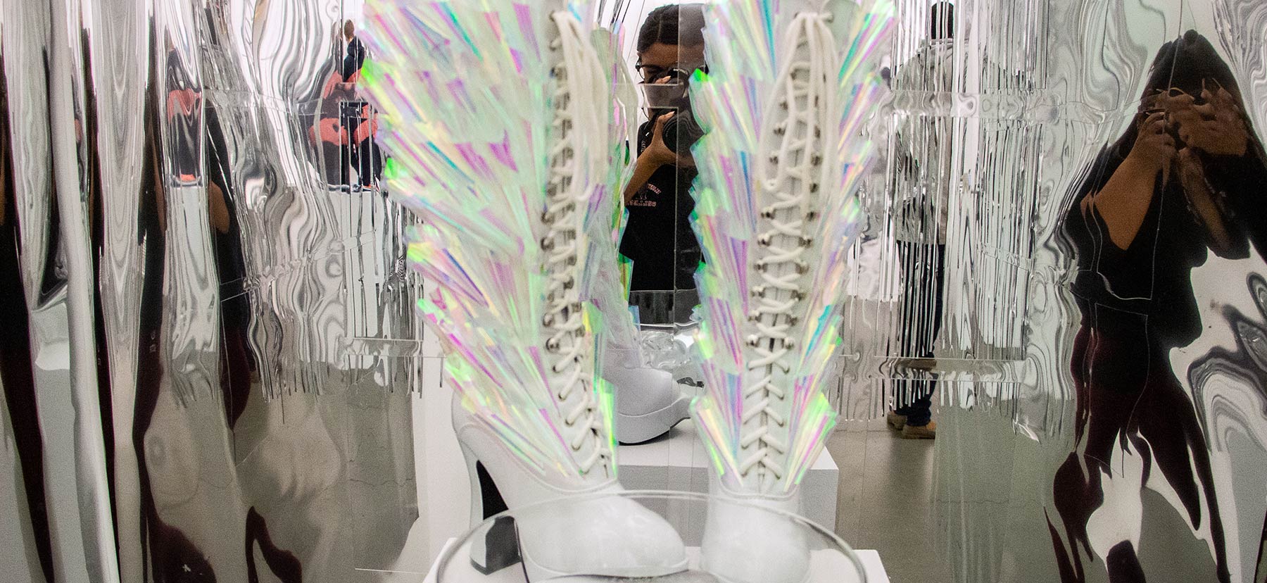 mirrored ribbons hang around boots decorated with reflective materials