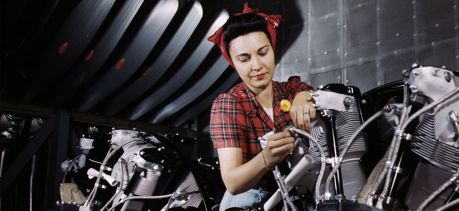 Woman works on an internal combustion engine