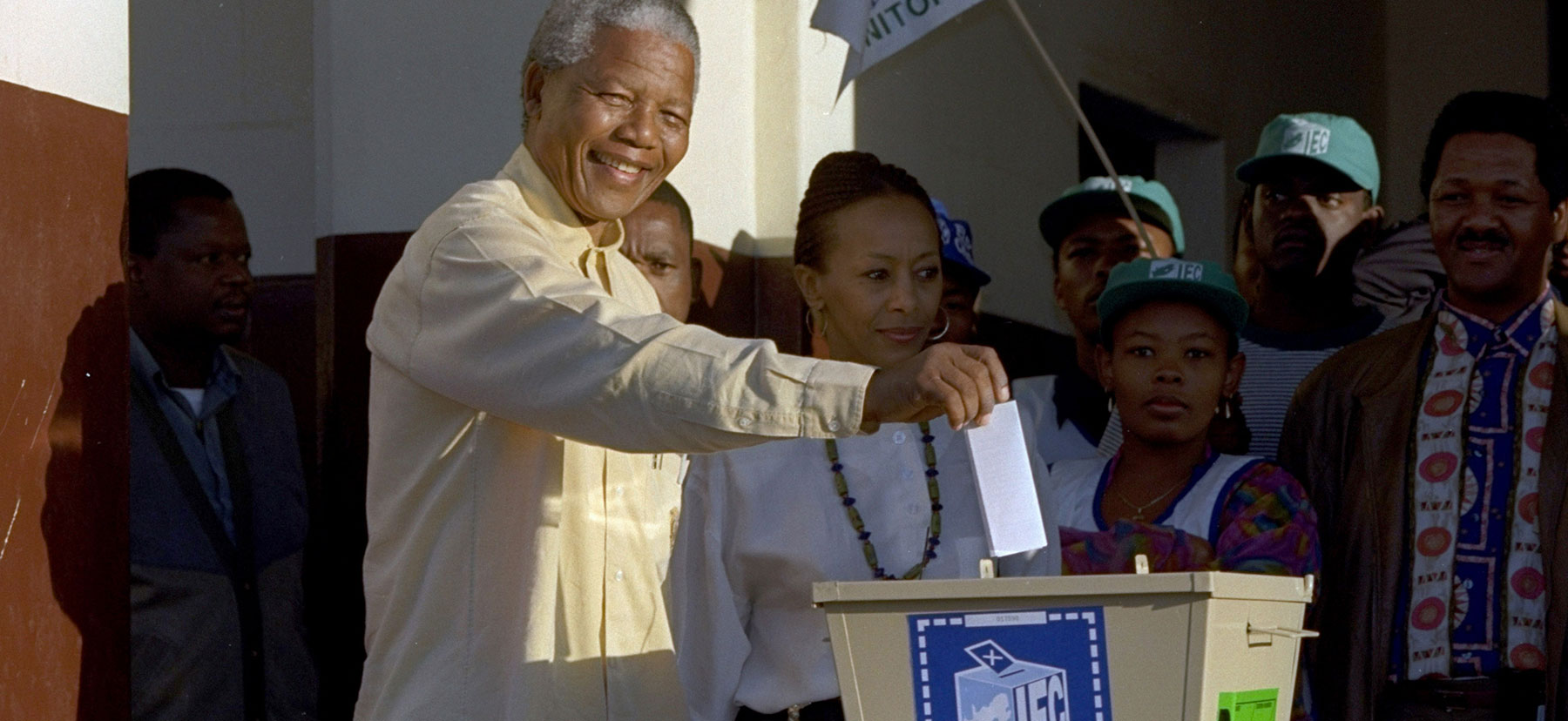 Nelson Mandela drops his ballot into a voting box