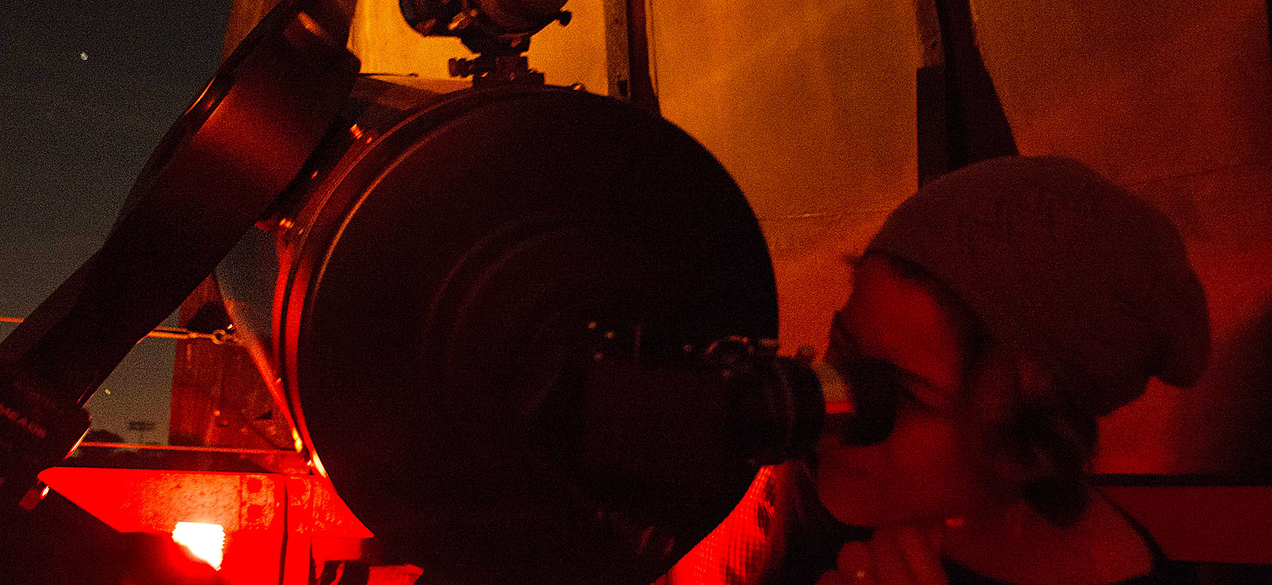 Person looking through a telescope