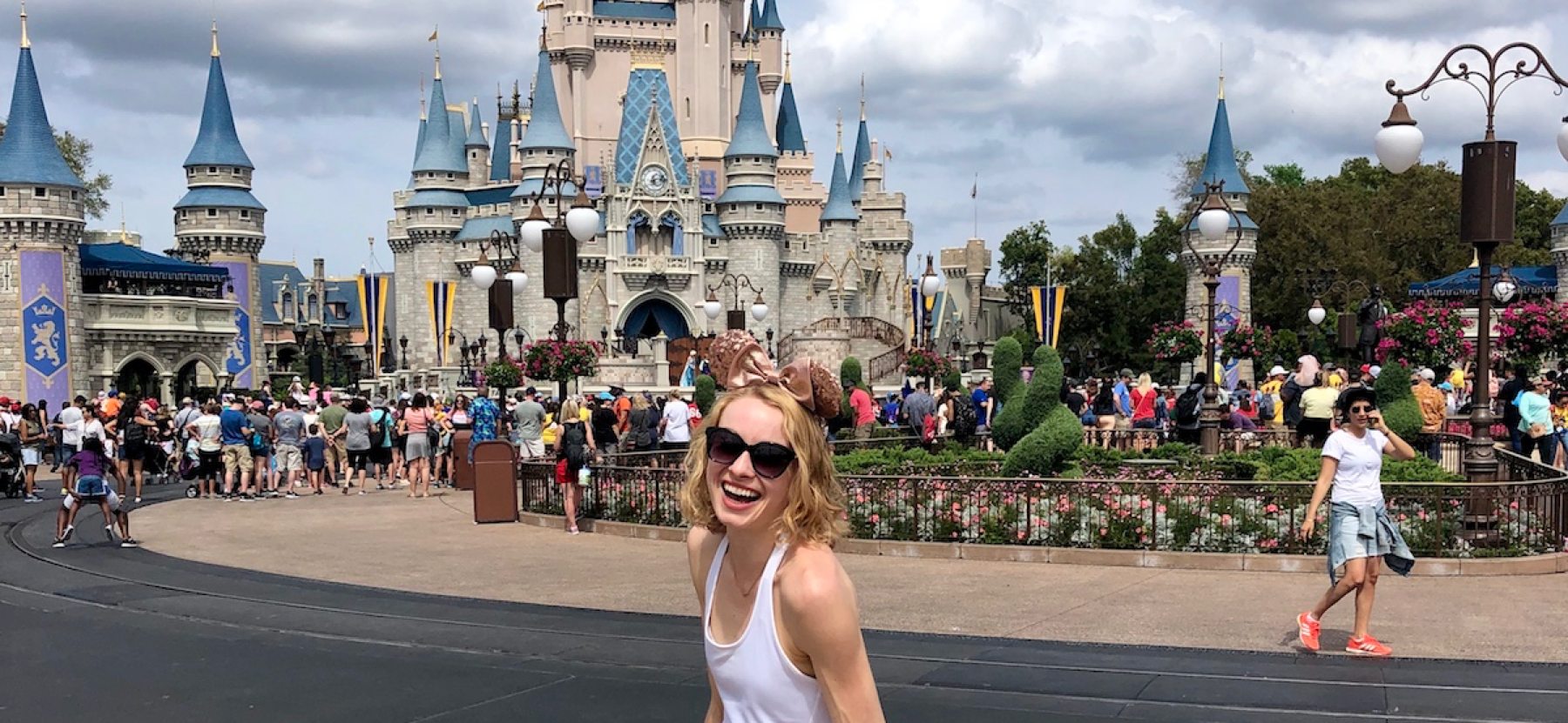 Smiling woman in front of Cinderella's castle at Disney World