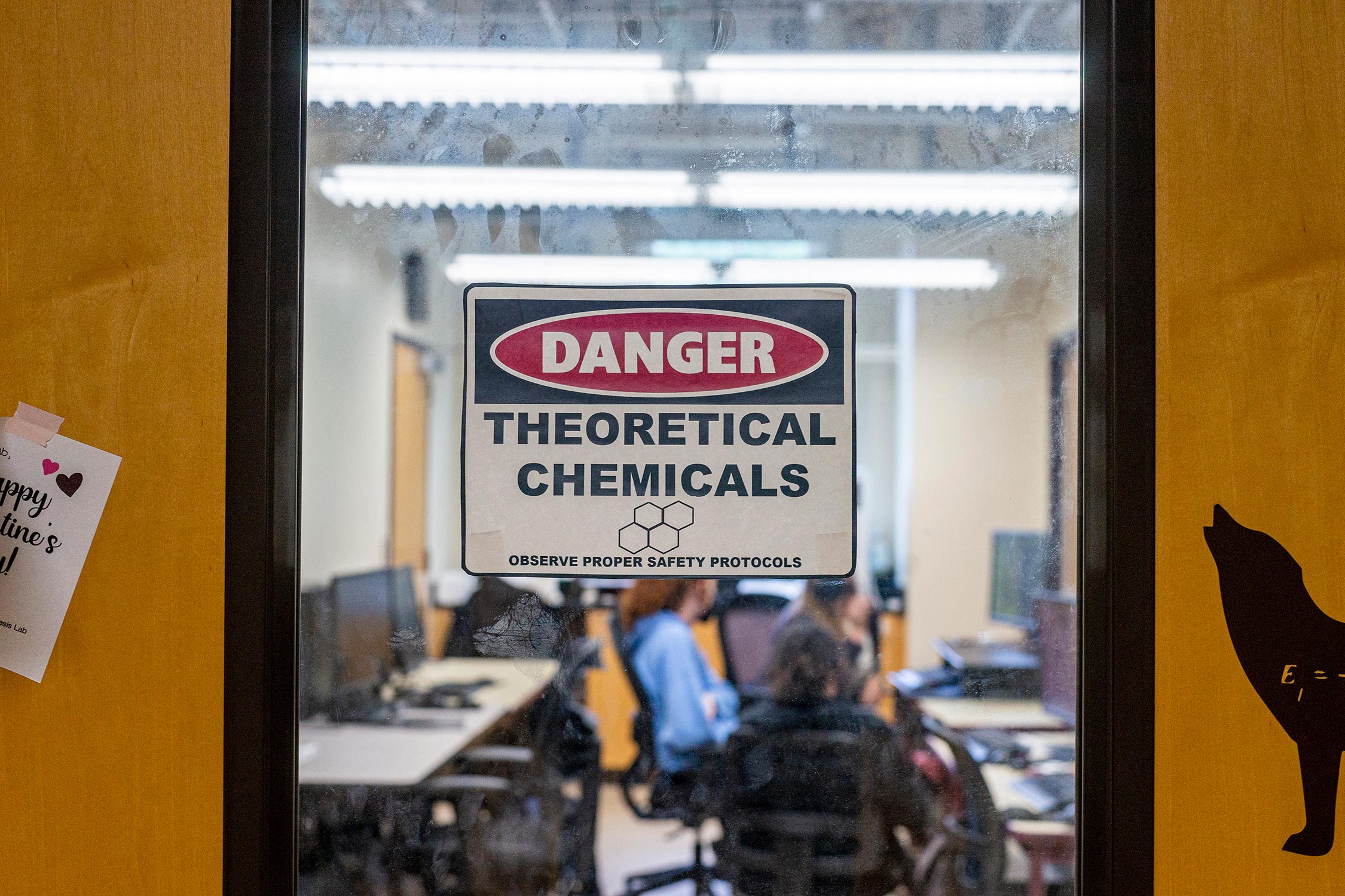 Sign on the door of the Daly Lab reading Danger Theoretical Chemicals