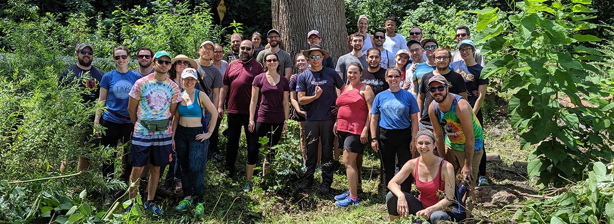 volunteers on the nature trail surrounded by lush plants and trees