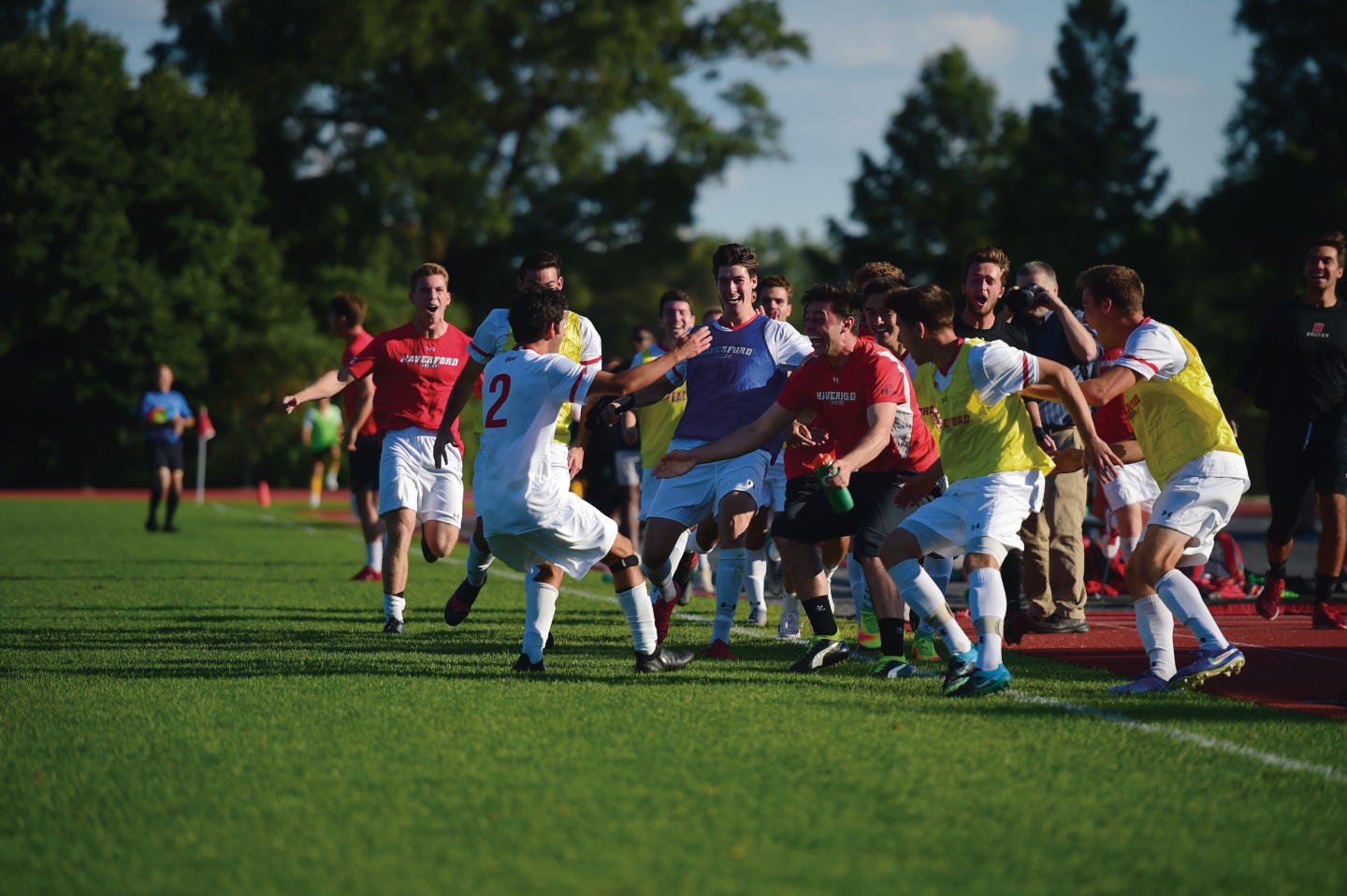 A Group of soccer plays run toward each other in celebration