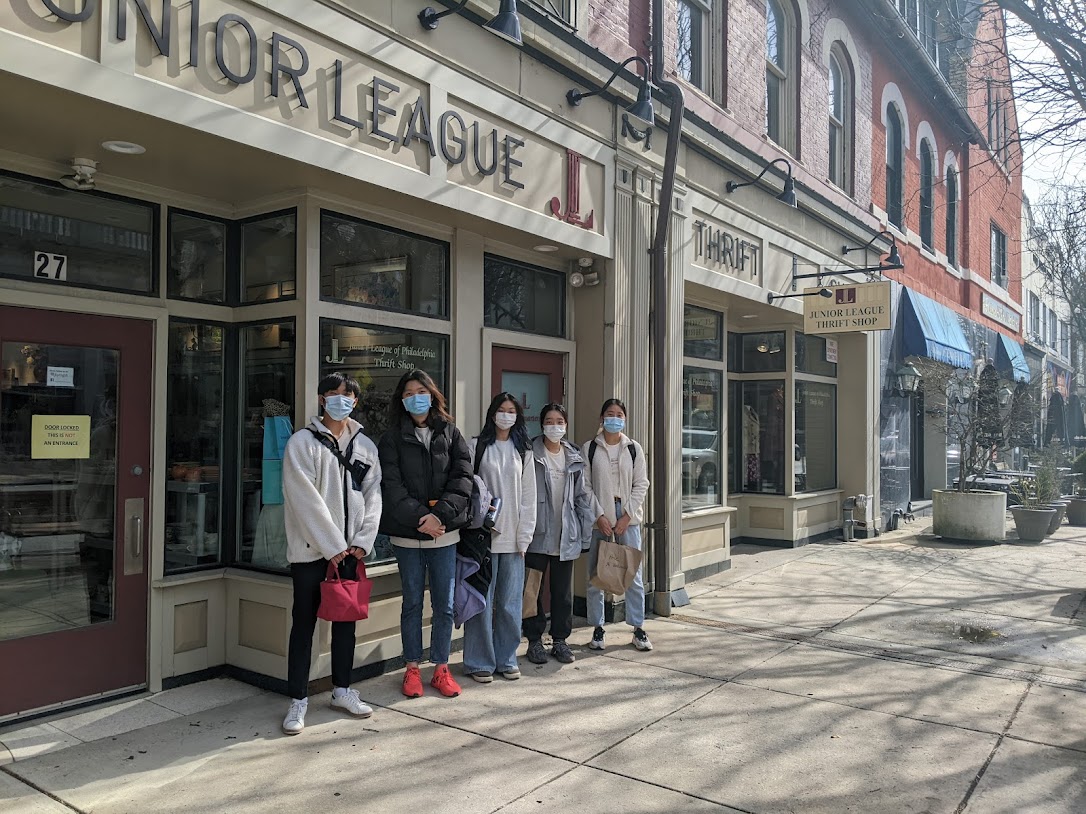 our masked students pose together outside of the thrift shop