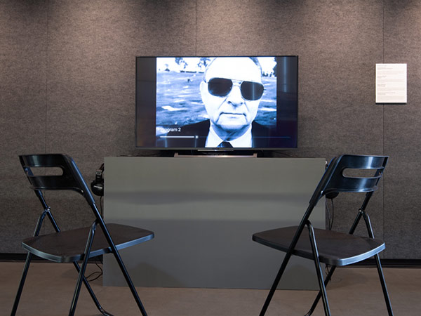 Two folding chairs placed in front of a viewing screen