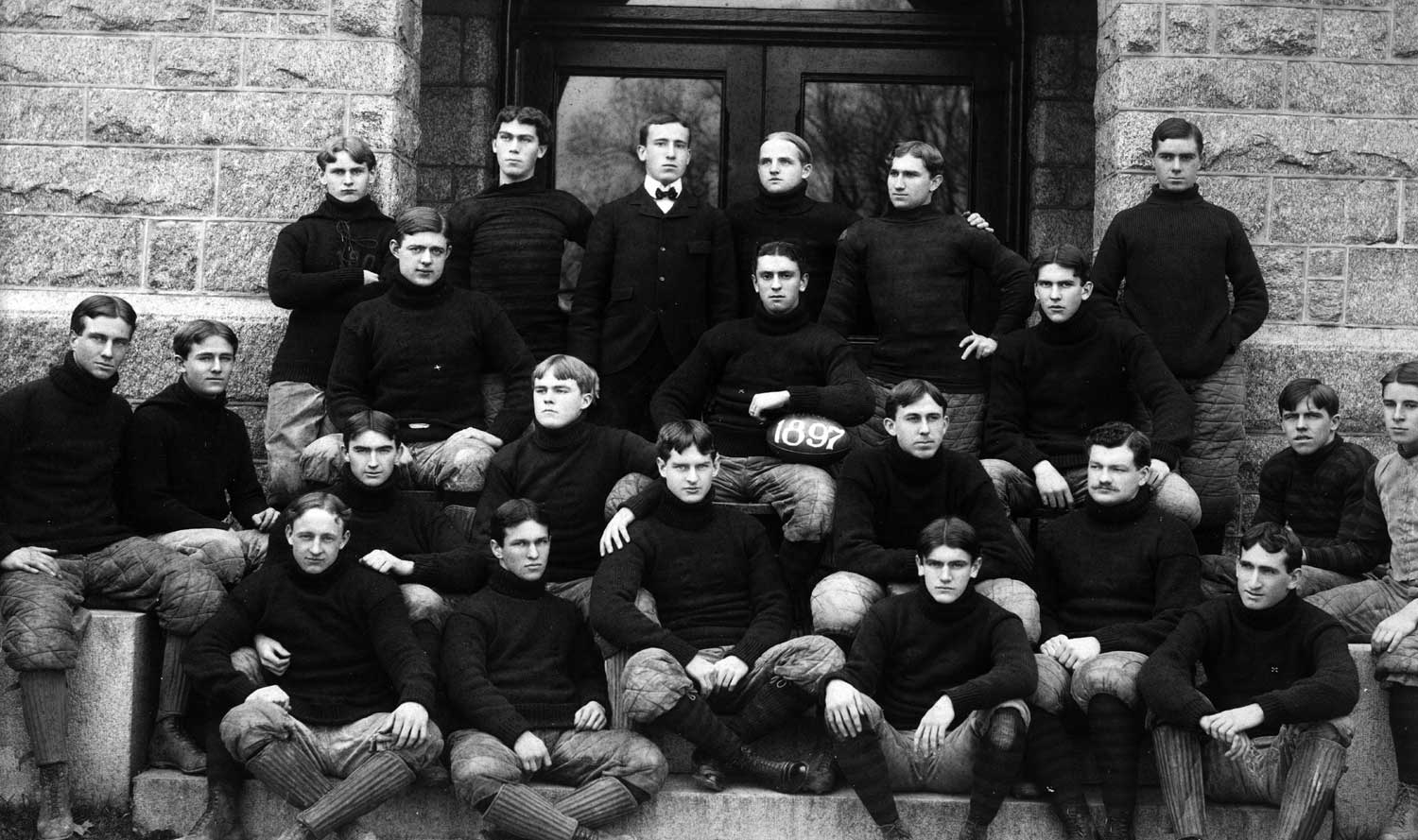 the football team poses together back in the late 1800s