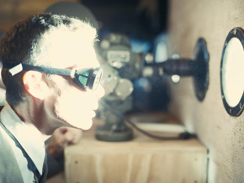 Actor Cilian Murphy, wearing protective goggles, portrays Robert J. Oppenheimer