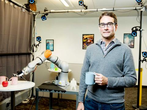 Eric Krotkov with a robotic arm