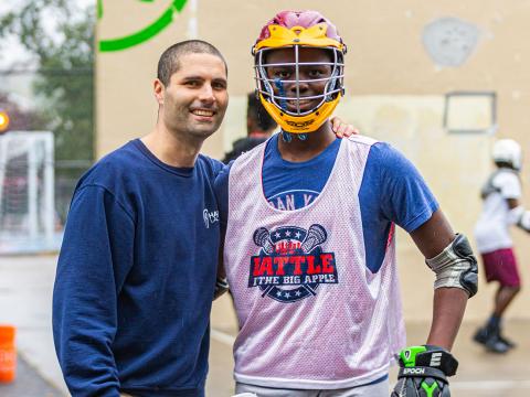 Joel Censor teaches lacrosse to students on handball courts