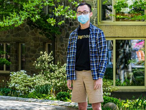 Theo Bien wears a mask in front of his dorm. 