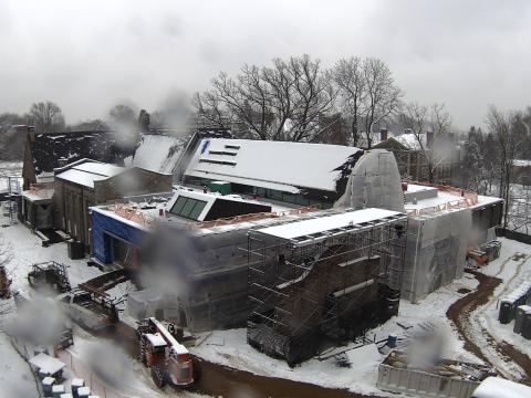 Exterior of the library under construction, covered in snow.