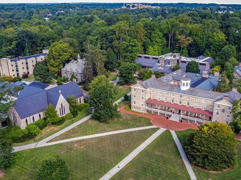 An arial view, captured with a drone, shows Haverford College's campus with a focus on Founder's Hall