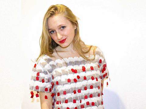 Photo of Jessie Lamworth posing in her "tea shirt," which she made out of tea bags.