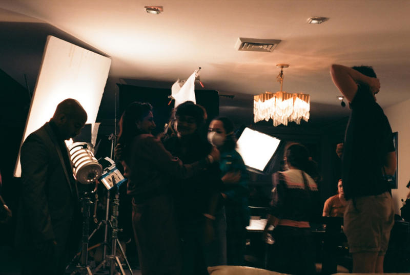 Film crew gathering in a shadowy room