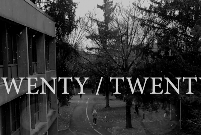 A black-and-white photo taken from a second story window of campus as it is snowing with the words "Twenty/Twenty" written on top of them