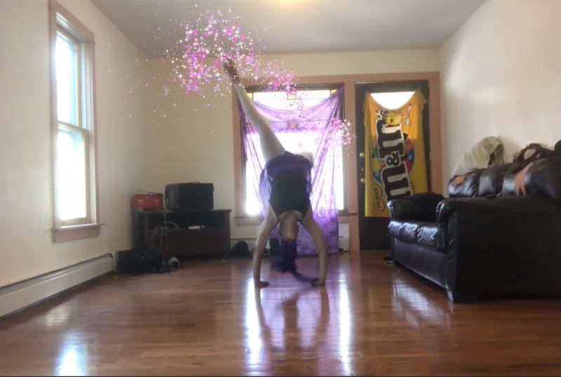 A woman doing a handstand with pink sparkles animated on top of her movement