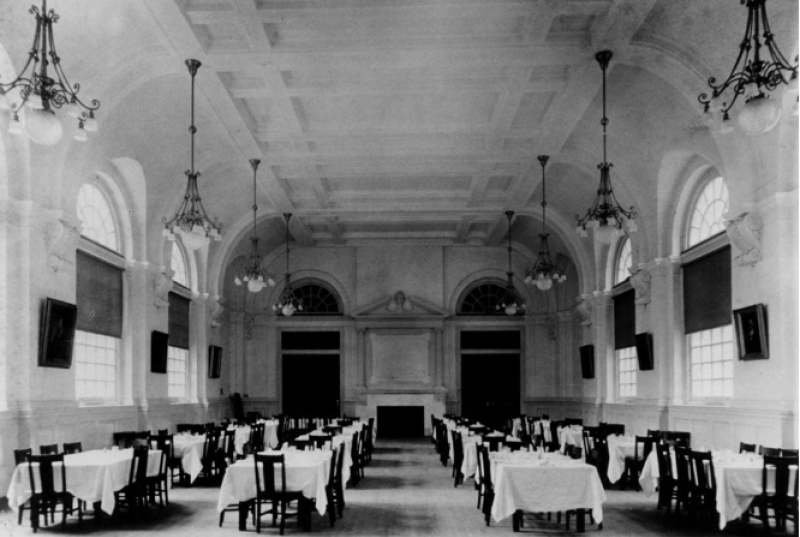 black and white photo of the Great Hall filled with tables, set up for a meal