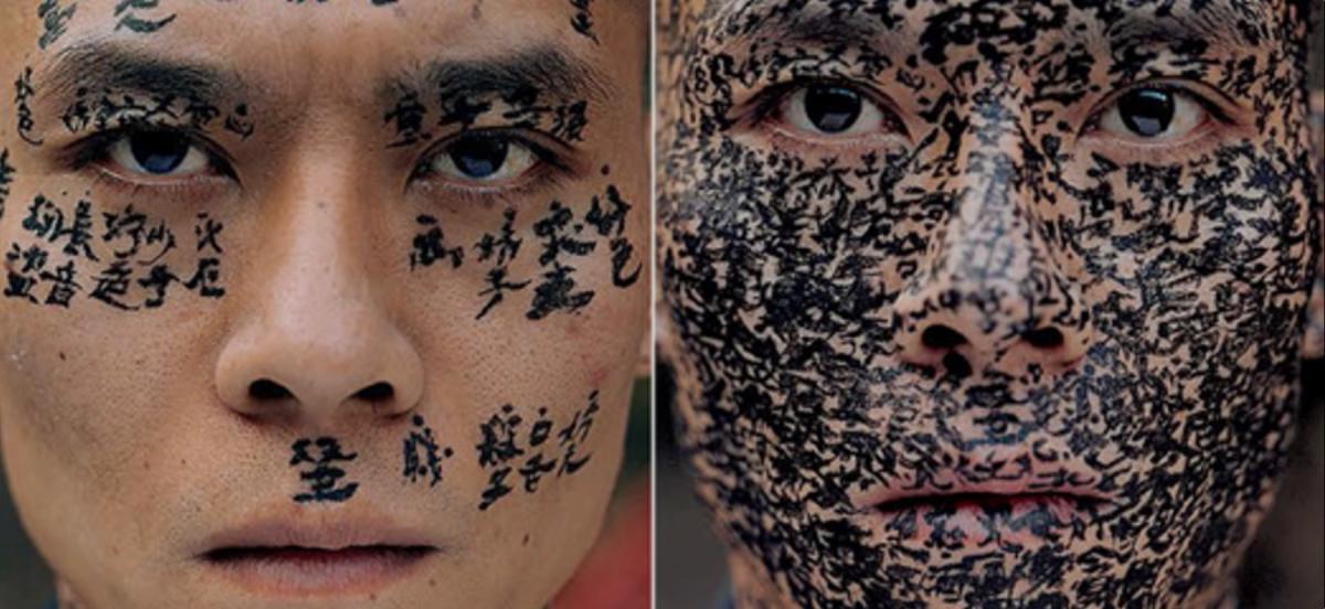 Two faces with Asian caligraphy painted on them.