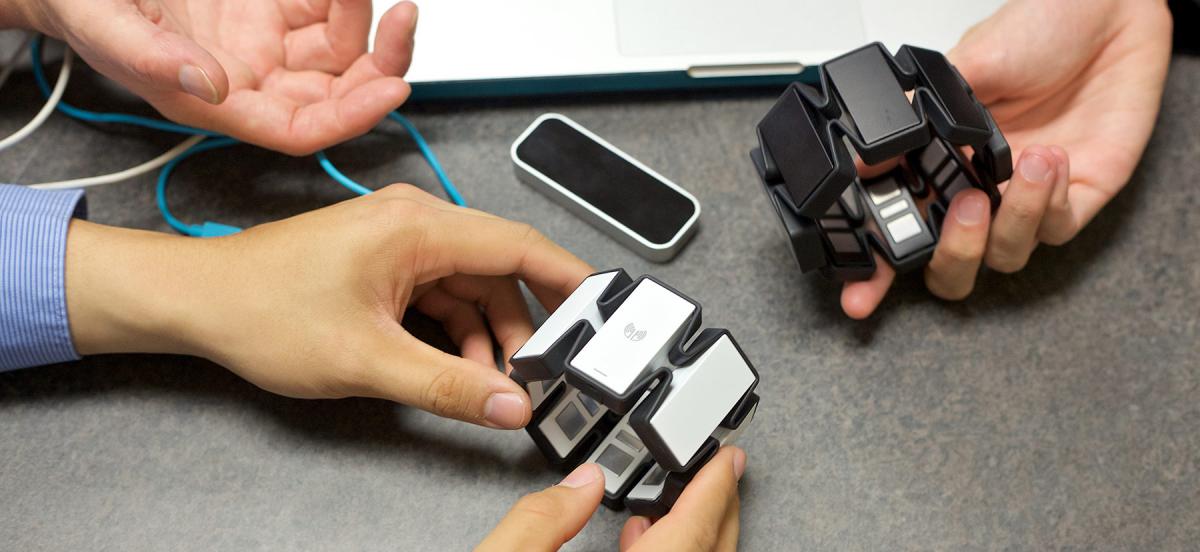 Students holding gesture recognition devices