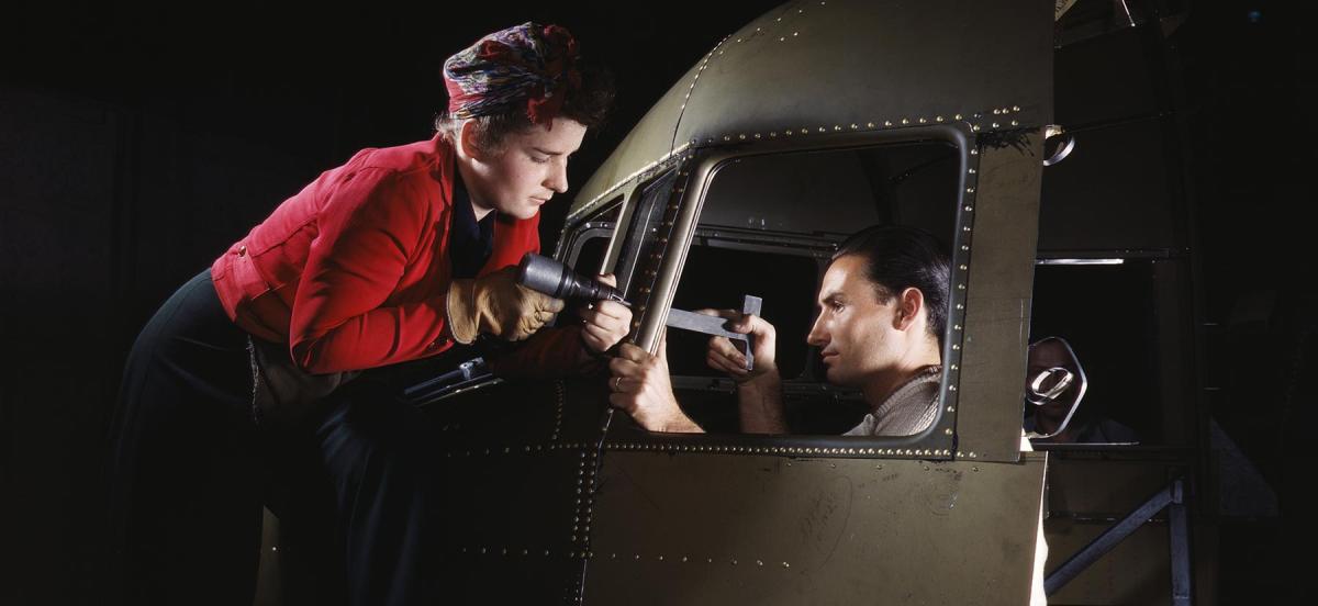 A man and woman riveting a cockpit
