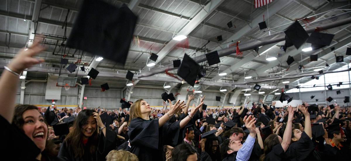 Graduates throw caps in the air
