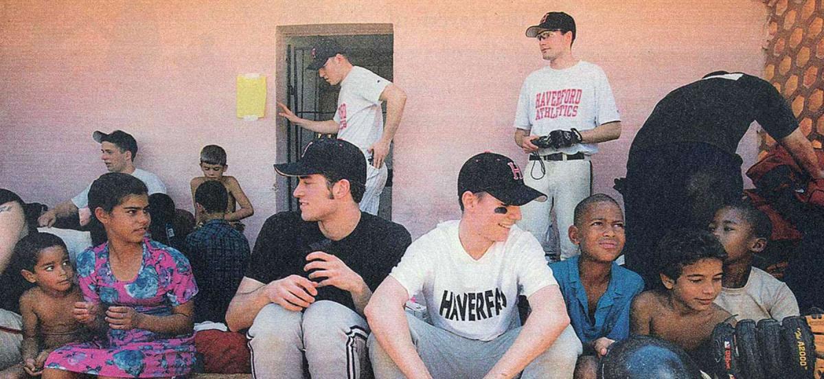 Members of the Haverford College baseball team with children in Cuba