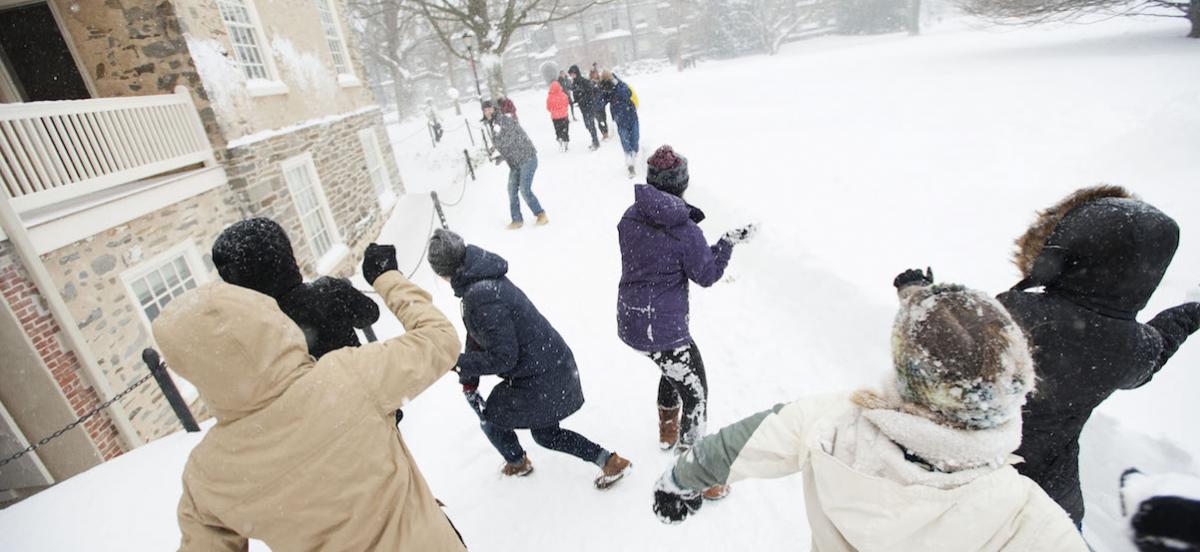 Students having a snowball fight on Founders Green