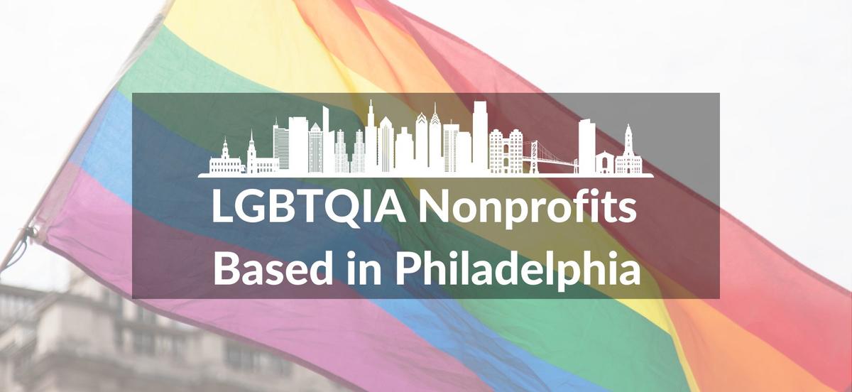 An image of a rainbow flag waving in the background. In the foreground, there is a white graphic of a Philadelphia cityscape. Below the graphic are the words LGBTQIA Nonprofits Based in Philadelphia.