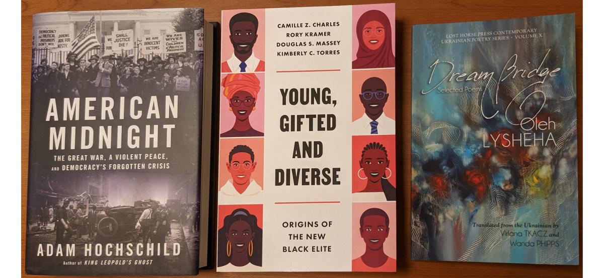 photo of three books: American Midnight with black and white photos of protests on the cover; Young, Gifted and Diverse with art of a variety of brown-skinned faces down the sides of the cover; Dream Bridge with an abstract textured painting cover.