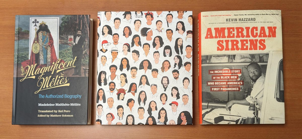 Photo of three books. Magnificent Melies features a photo of Melies standing beside a huge King playing card. Rise features drawings of faces of Asian American celebrities. American Sirens features a sepia photo of a Black paramedic in an ambulance