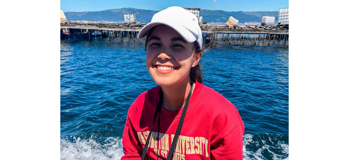 Annemarie Wood '23 sits on a boat at Spain's Bottlenose Dolphin Research Institute, smiling.