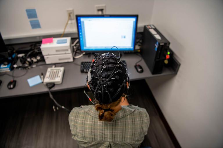 Amanda Halliday '23 wears an EEG in Professor Compton's psychology lab. Photo: Holden Blanco '17